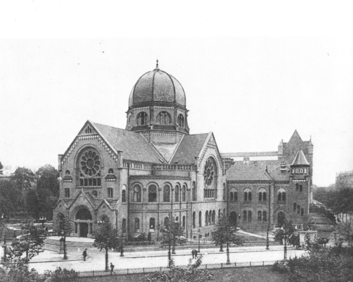 schwarz-weiß Foto einer Synagoge mit Kuppeldach in der Mitte und großen runden Fenstern an zwei Giebeln.